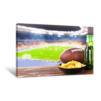 Image of Beer With Snack And Ball On Wooden Table Against Football Field Background  Sport And Entertainment Concept Canvas Print
