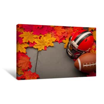 Image of Thanksgiving American Football Game Concept With Copy Space, A Generic Helmet And Ball On The Pavement Surrounded By Fall Foliage Leafs In Autumn Canvas Print