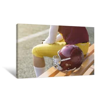 Image of American Football Player Sitting On Bench And Helmet Next To Him Canvas Print