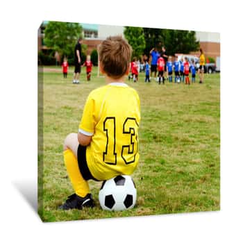 Image of Boy  Watching Organized Youth Soccer Game From Sidelines Canvas Print