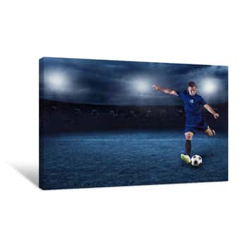 Image of Professional Soccer Or Football Player During Game In Full Floodlit Stadium At Night Canvas Print
