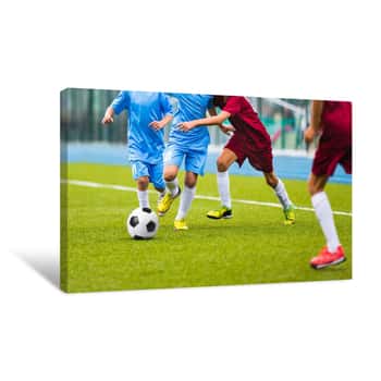 Image of Young Soccer Players Running Towards Soccer Ball  Football Soccer Game For Youth Teams  Children Playing Soccer Match Canvas Print