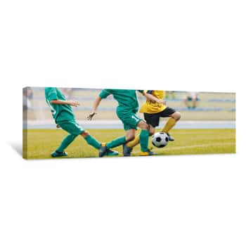 Image of Young Junior Football Match  Players Running And Kicking Football Ball Canvas Print