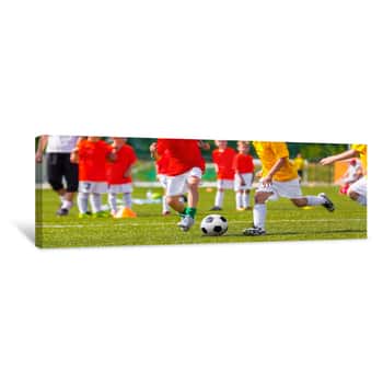 Image of Children Football Match  Boys Boys Playing Soccer Match On Professional Football Pitch  Football Stadium In The Background Canvas Print
