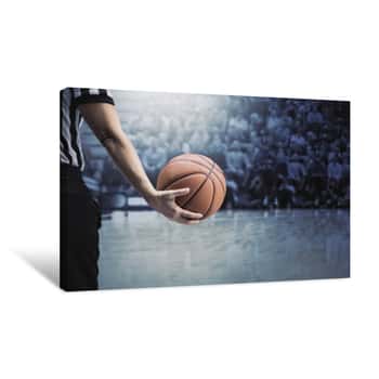 Image of Basketball Referee Holding A Basketball At A Game In A Crowded Sports Arena  Holding The Ball In His Hand During A Timeout  Selective Focus On The Ball  The Fans And Crowd And Basketball Court Canvas Print