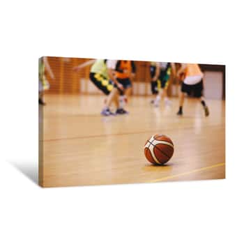 Image of Basketball Training Game Background  Basketball On Wooden Court Floor Close Up With Blurred Players Playing Basketball Game In The Background Canvas Print