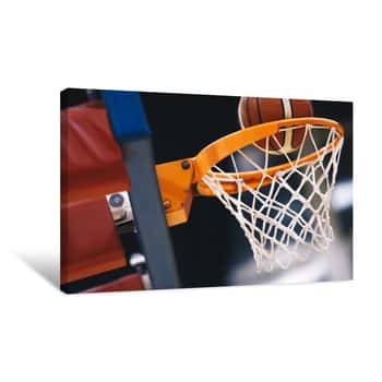 Image of Basketball Scoring Basket At A Sports Arena  Scoring The Winning Points At A Basketball Game  The Orange Basketball Ball Flies Through The Basket Canvas Print