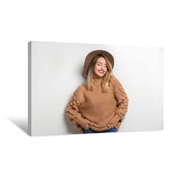 Image of Beautiful Young Woman In Warm Sweater With Hat On White Background Canvas Print