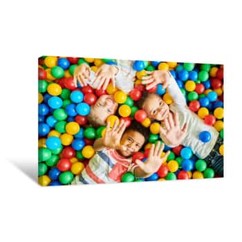 Image of Above View Portrait Of Three Happy Little Kids In Ball Pit Smiling At Camera Raising Hands While Having Fun In Children Play Center, Copy Space Canvas Print