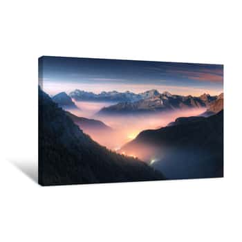Image of Mountains In Fog At Beautiful Night In Autumn In Dolomites, Italy  Landscape With Alpine Mountain Valley, Low Clouds, Forest, Colorful Sky With Stars, City Illumination At Dusk  Aerial  Passo Giau Canvas Print