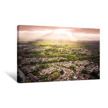 Image of Sun Bursting Through Clouds Over Traditional British Houses With Countryside In The Background  Dramatic Lighting And Warm Colours To Give A Homely Effect Canvas Print