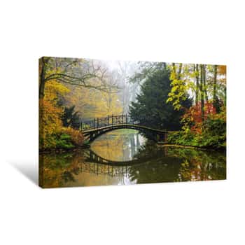 Image of Scenic View Of Misty Autumn Landscape With Beautiful Old Bridge In The Garden With Red Maple Foliage Canvas Print