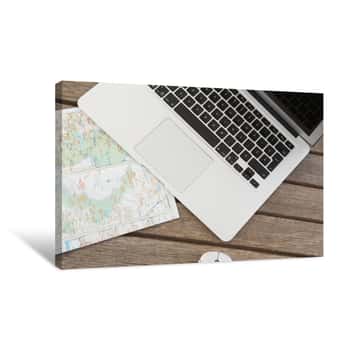 Image of Laptop And World Map On Wooden Plank Canvas Print