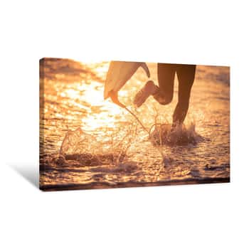 Image of Surfer Running In The Water With His Board Canvas Print