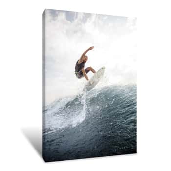 Image of Man Jumping On The White Wakeboard Down The Blue Water Against Grey Sky Canvas Print