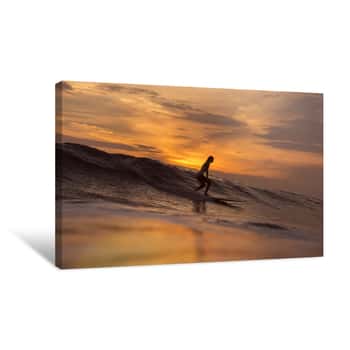 Image of Surfer Girl In Ocean At Sunset Time Canvas Print
