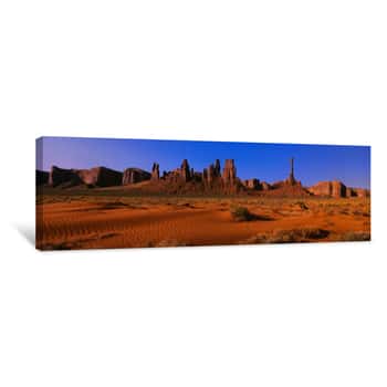Image of This Is Yei Bi Chei And The Totem Pole At Sunrise  In Front Are The Sand Dunes Of Monument Valley Canvas Print