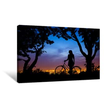 Image of A Young Woman Is Standing With Bicycle, Resting, With The Night Sky Background Canvas Print