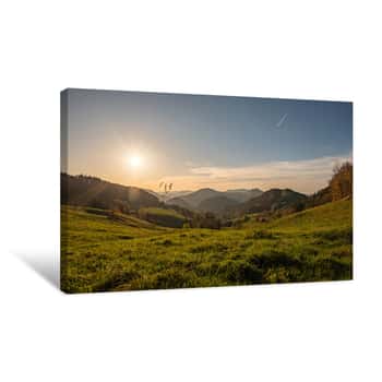 Image of A Meadow In The  Swiss Jura Mountains At Sunset With Green Grass In Foreground And Green Hills Covered With Forests And Fields In Background Canvas Print