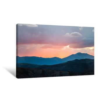 Image of Orange Red Soft Light Cloudy Sunset Sun Rays In Aspen, Colorado With Rocky Mountains Peak And Vibrant Color Of Clouds At Twilight With Mountain Ridge Silhouette Canvas Print