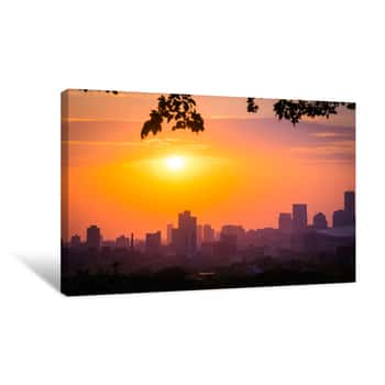 Image of Sunset With The Minneapolis Minnesota Skyline Framed With Leaves And Branches  Sky Is Pink, Orange, Blue And Purple Canvas Print