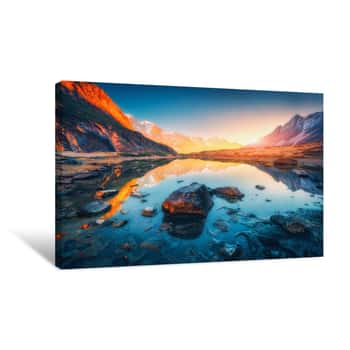 Image of Beautiful Landscape With High Mountains With Illuminated Peaks, Stones In Mountain Lake, Reflection, Blue Sky And Yellow Sunlight In Sunrise  Nepal  Amazing Scene With Himalayan Mountains  Himalayas Canvas Print