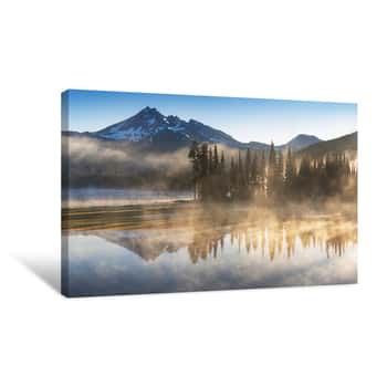 Image of South Sister And Broken Top Reflect Over The Calm Waters Of Sparks Lake At Sunrise In The Cascades Range In Central Oregon, USA In An Early Morning Light  Morning Mist Rises From Lake Into Trees Canvas Print