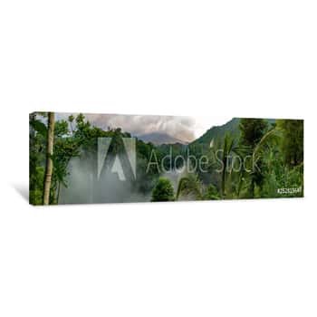 Image of Aerial Over Sekumpul Waterfall Surrounded By Dense Rainforest And Mountains Shrouded In Mist At Sunrise, Bali, Indonesia Panoramic Canvas Print