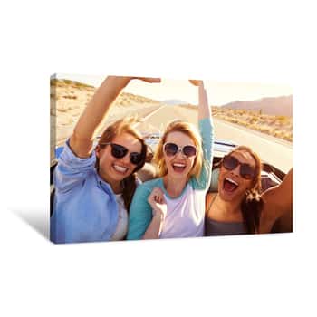 Image of Three Female Friends On Road Trip In Back Of Convertible Car Canvas Print