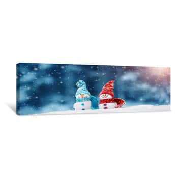 Image of Little Knitted Snowmans On Soft Snow On Blue Background Canvas Print