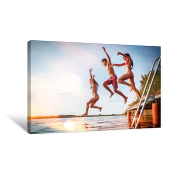 Image of Group Of Friends Jumping Into The Lake From Wooden Pier Having Fun On Summer Day Canvas Print