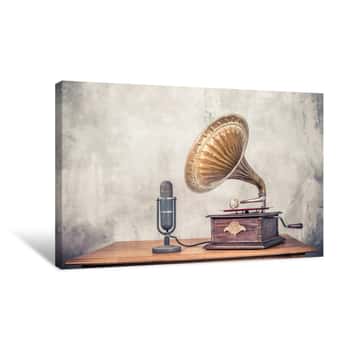 Image of Vintage Antique Gramophone Phonograph Turntable With Brass Horn And Big Aged Studio Microphone On Wooden Table Front Concrete Wall Background  Retro Old Style Filtered Photo Canvas Print