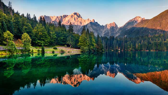 Calm Morning View Of Fusine Lake  Colorful Summer Sunrise In Julian Alps With Mangart Peak On Background, Province Of Udine, Italy, Europe  Beauty Of Nature Concept Background  Wall Mural